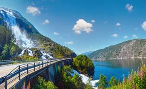Summer mountain Langfossen waterfall on slope (Etne, Norway)