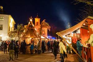 Weihnachtsmarkt Festung Königstein mit Marktbuden und Kirchturm bei Nacht
